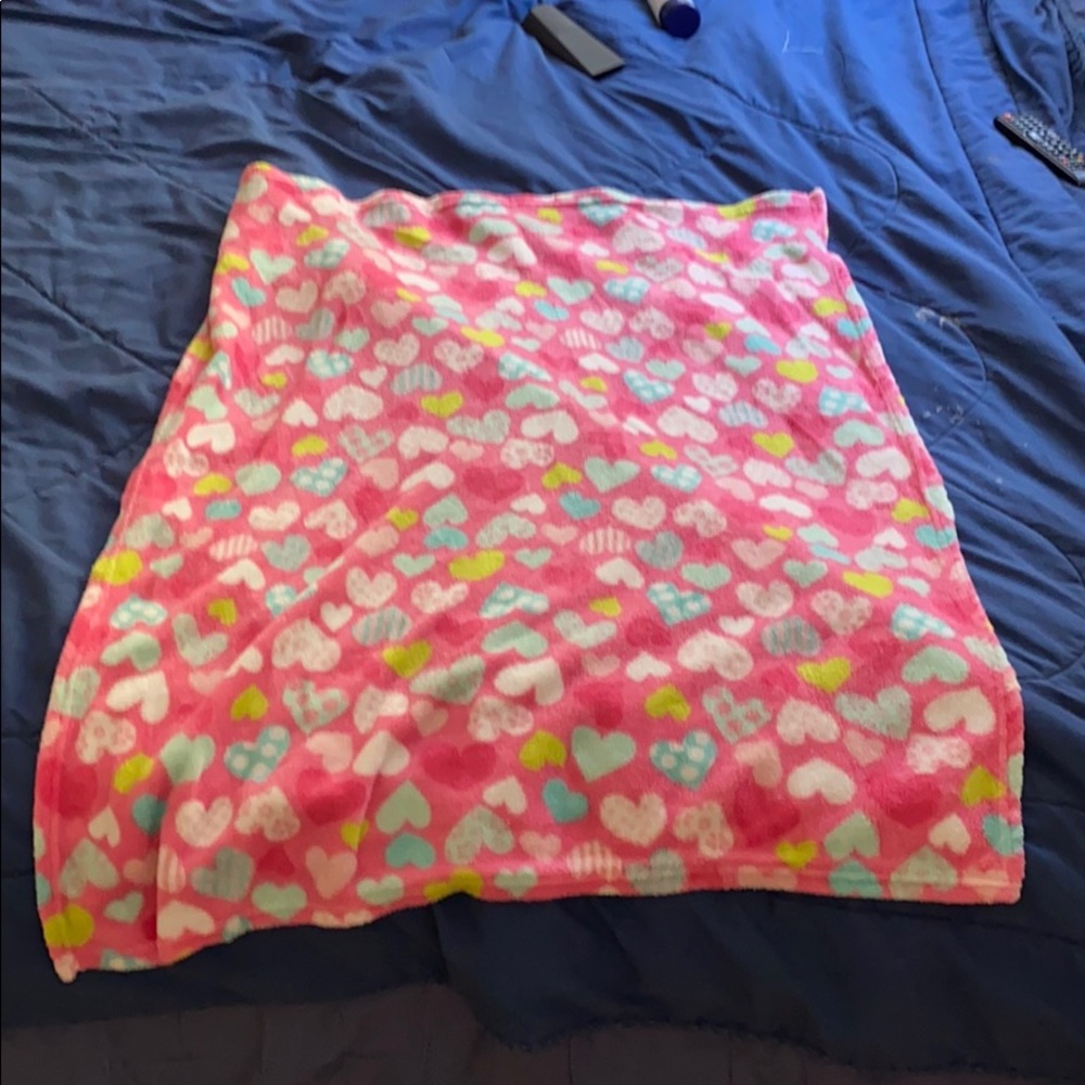 this is a pink baby blanket with hearts.